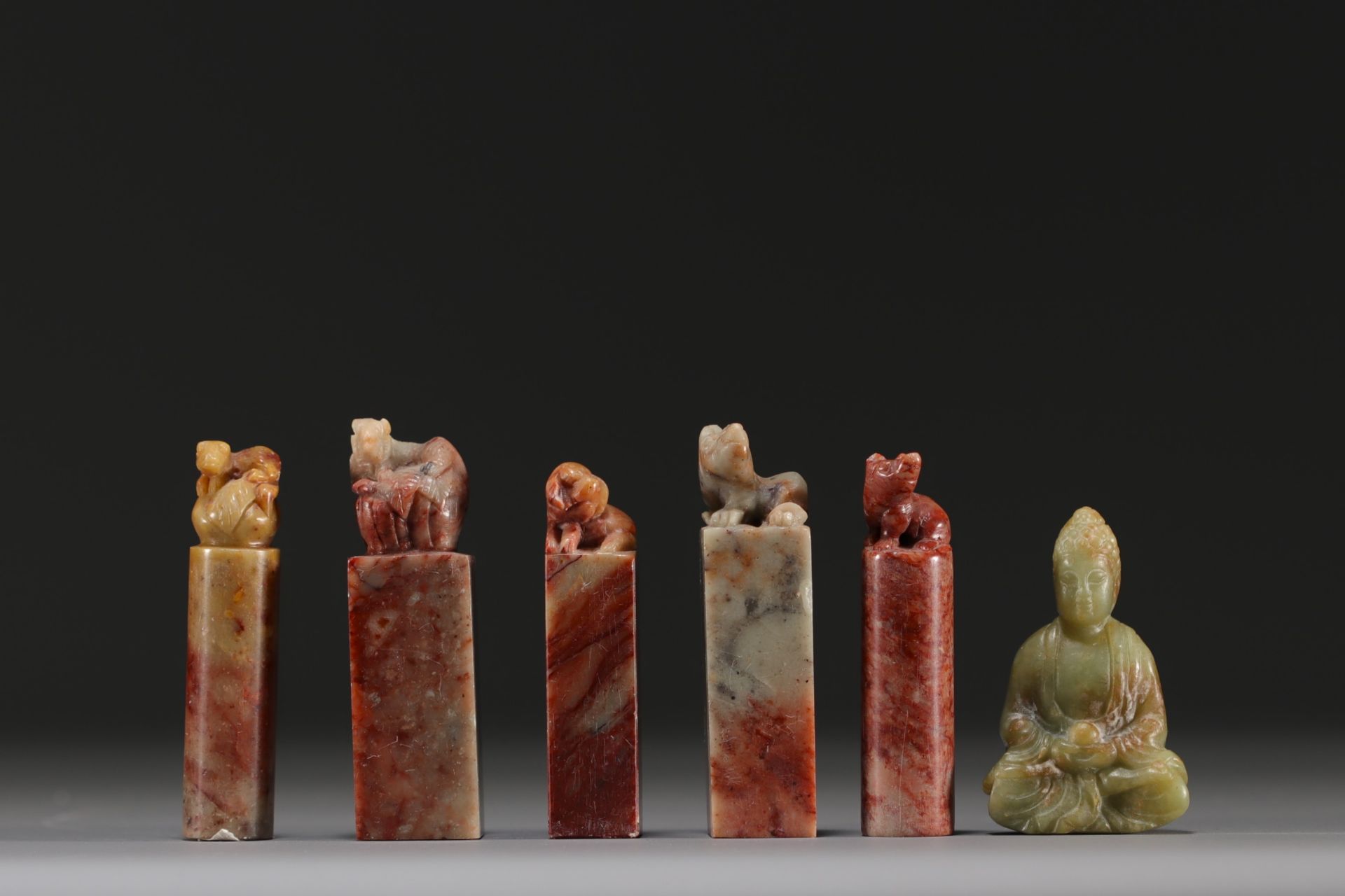 China - Set of five hard stone seals and a carved jade figure.