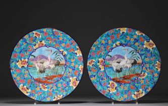 Longwy - Pair of large enameled plates decorated with cranes.