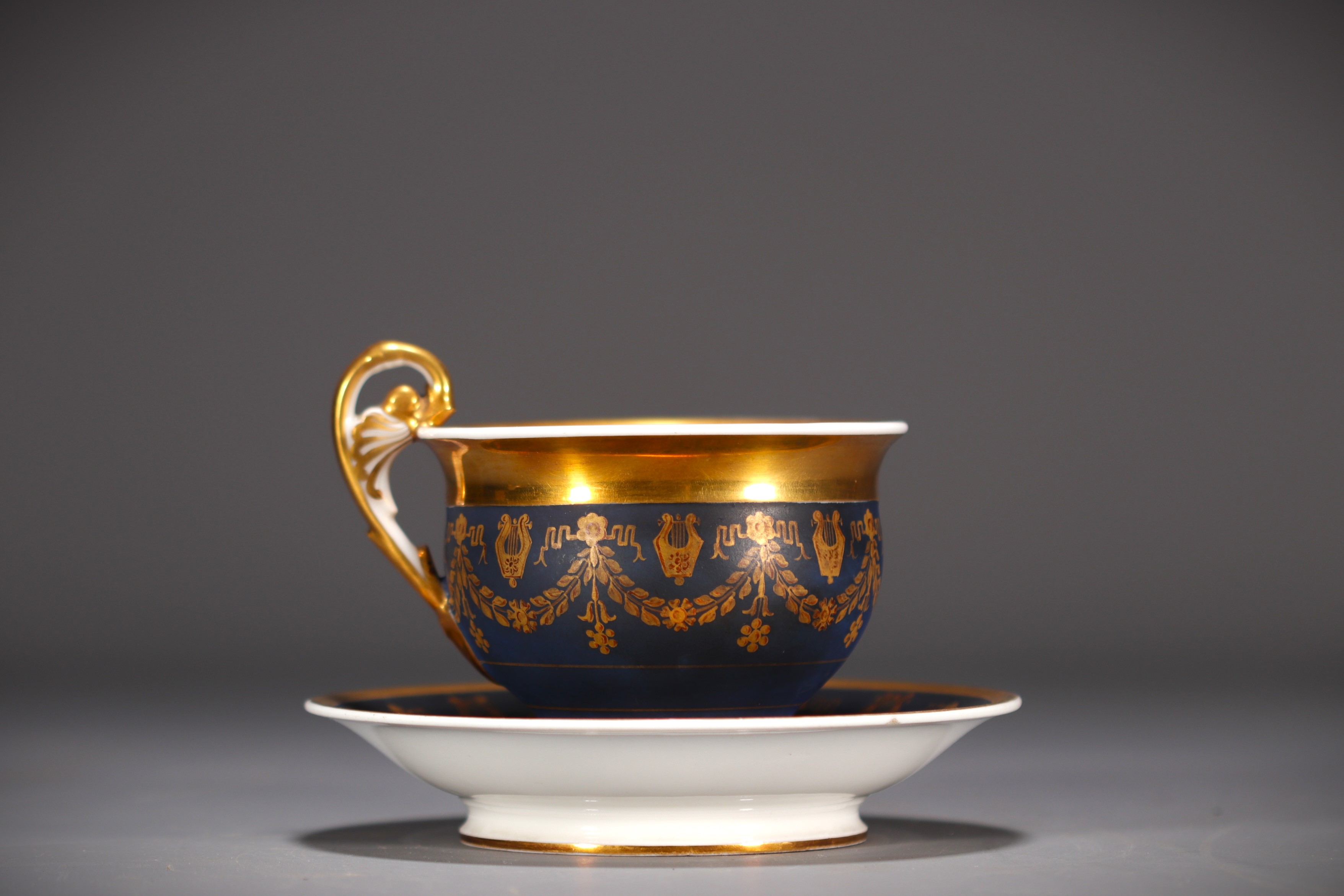 Blue and gold porcelain chocolate cup and saucer, Empire, 19th century.