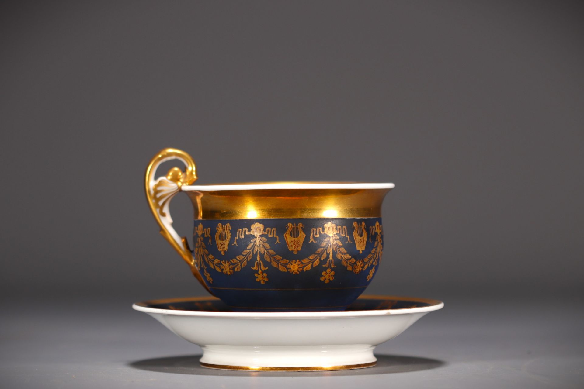 Blue and gold porcelain chocolate cup and saucer, Empire, 19th century.
