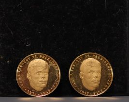 Set of two gold coins commemorating John F. Kennedy (1917-1963).