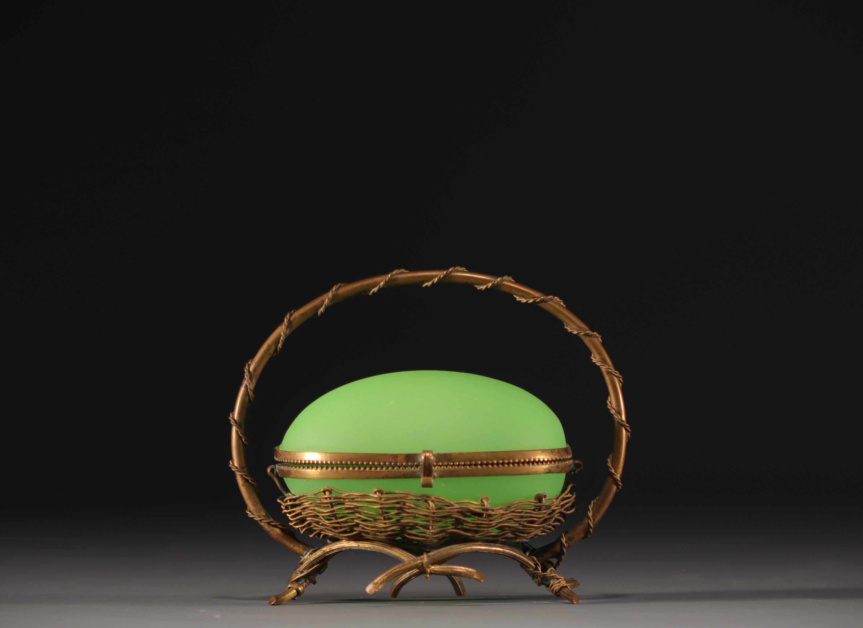 A Napoleon III period egg-shaped jewellery box in green opaline with brass mount.