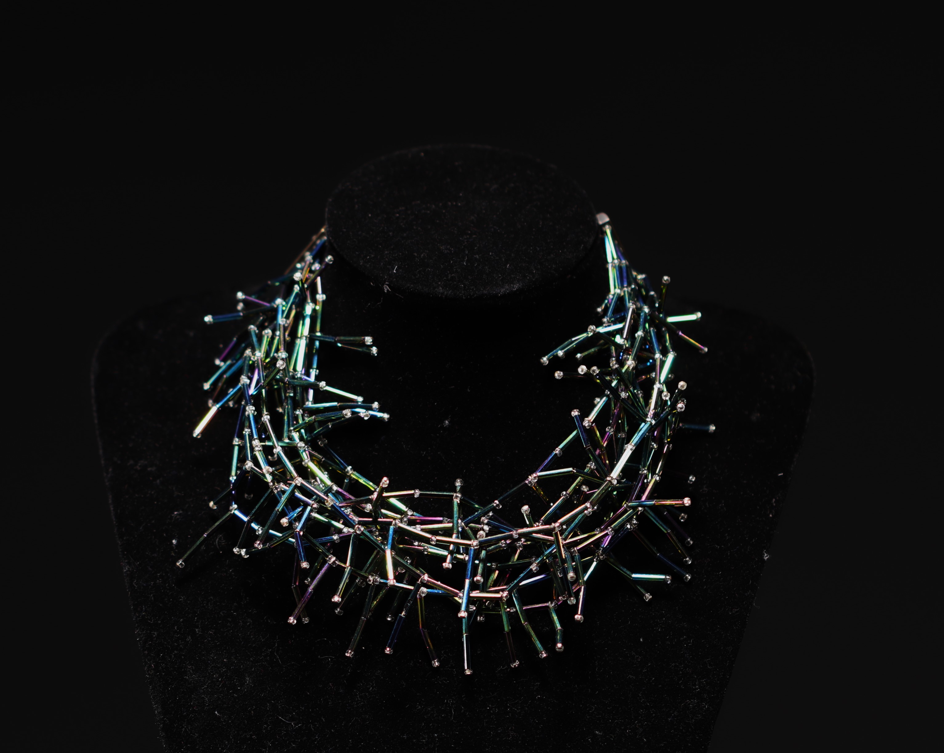 Yves SAINT LAURENT - Set of iridescent tubular pearls.