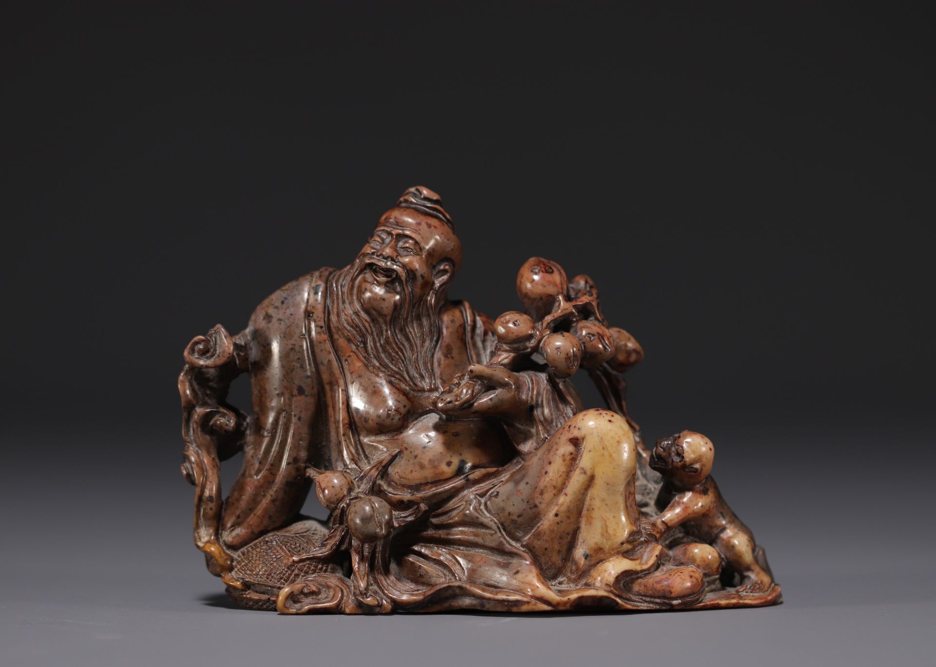 China - Dignitary with monkey in hard stone, representing three characters, 18th-19th century.