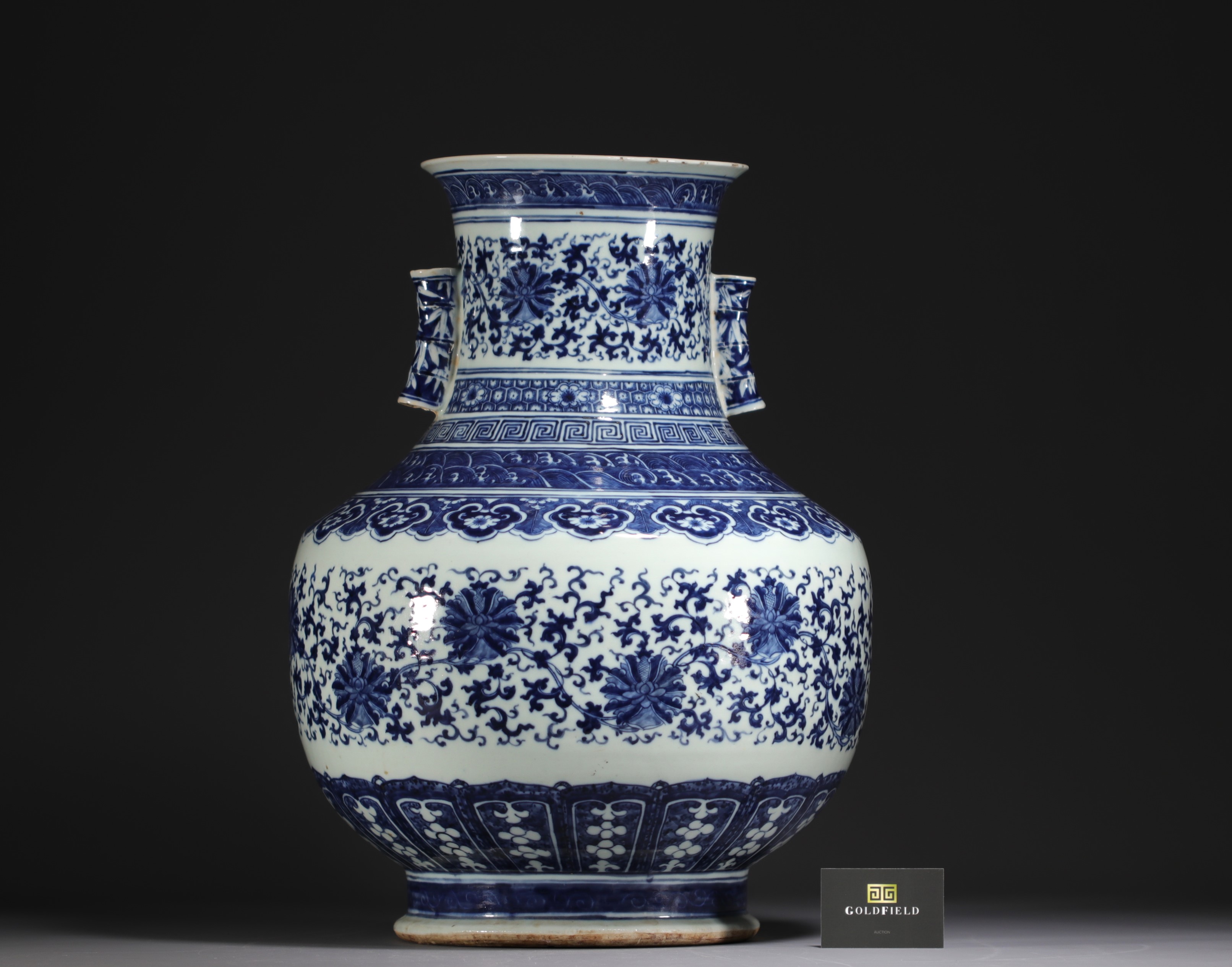 China - Large Hu-shaped vase in blue-white porcelain with floral decoration and bamboo handles, 19th