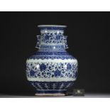 China - Large Hu-shaped vase in blue-white porcelain with floral decoration and bamboo handles, 19th