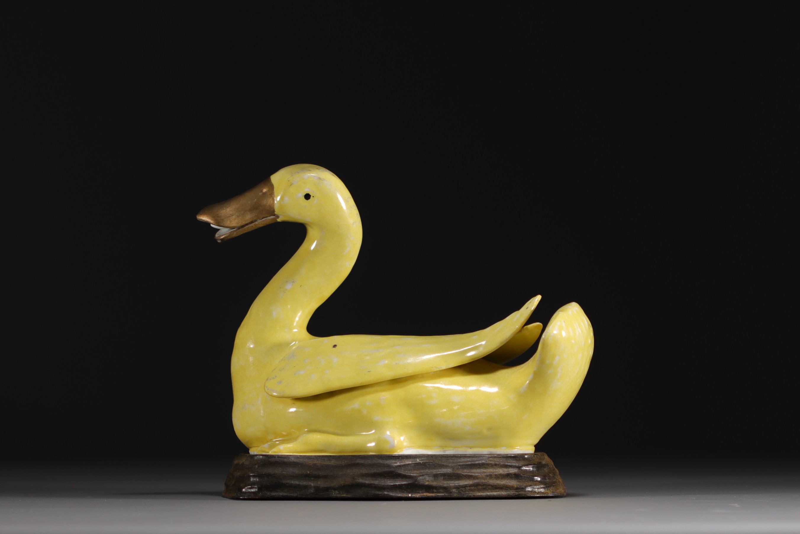 China - Yellow porcelain duck on wooden base, Qing period.