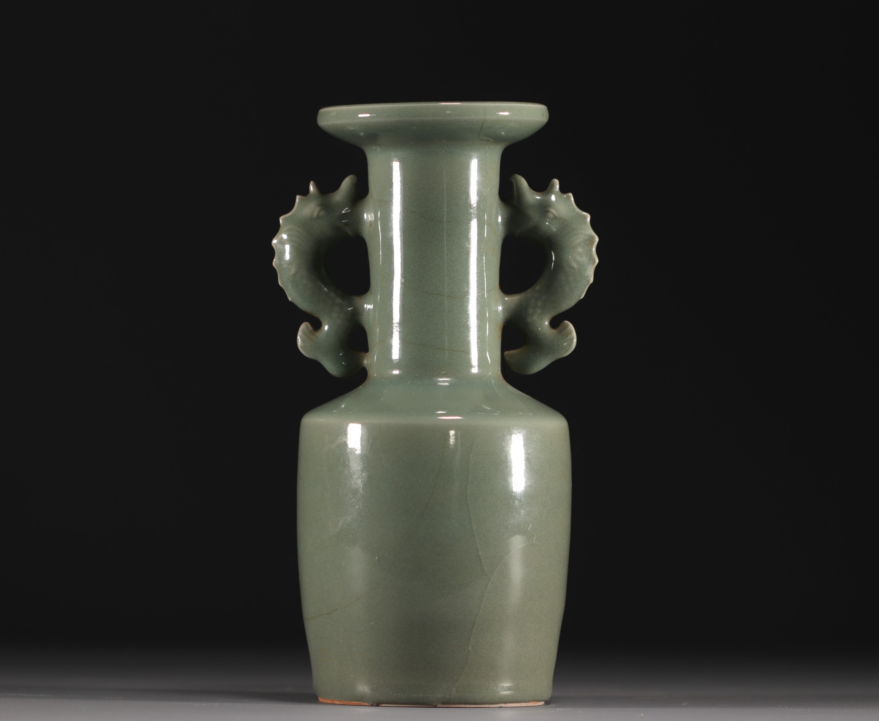 China - A green-glazed monochrome porcelain vase with fish-shaped handles, Qing period.