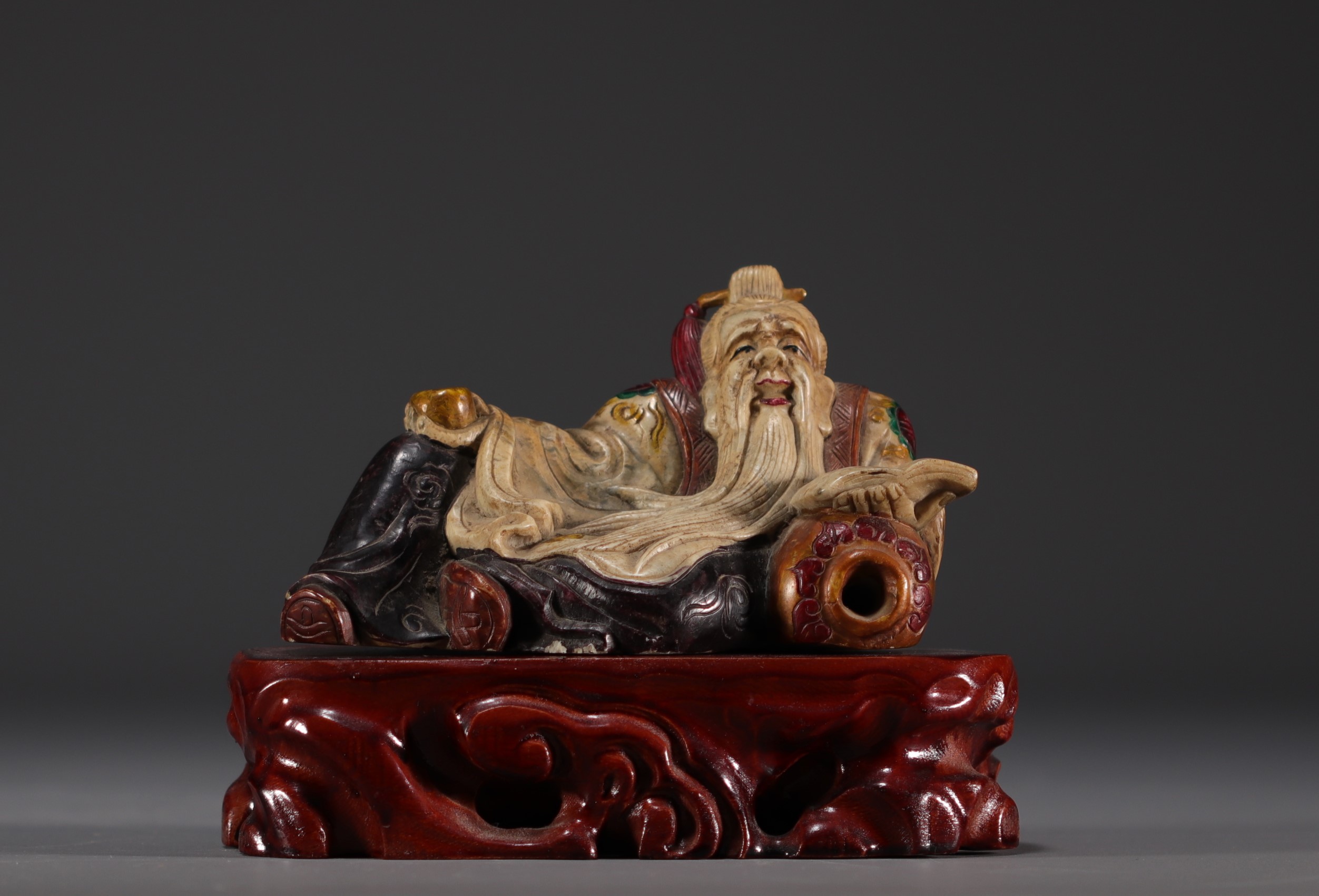 China - Polychrome stone sculpture of a Dignitary on a wooden base.