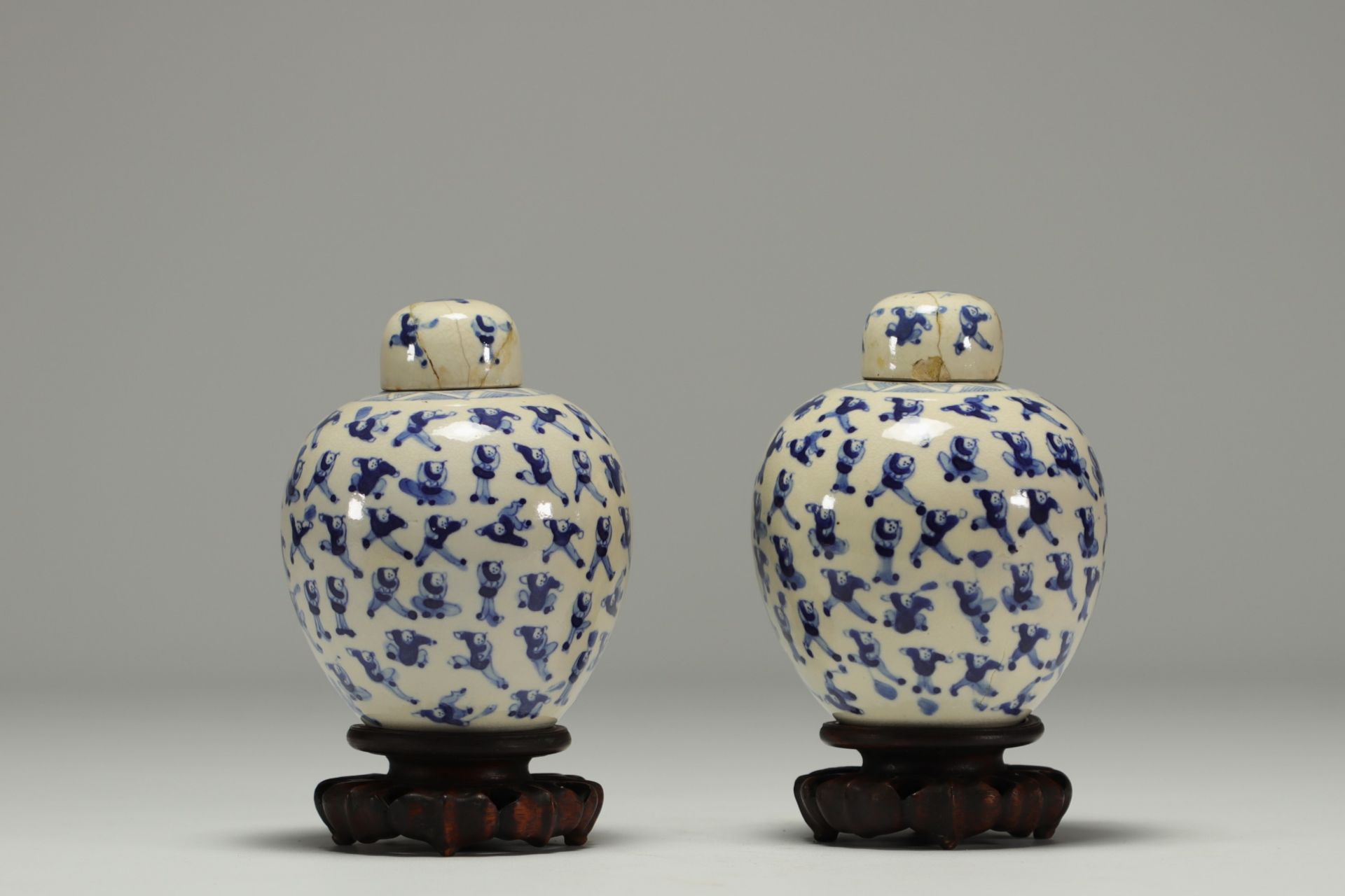 China - Pair of white-blue porcelain covered pots with children, wooden base.