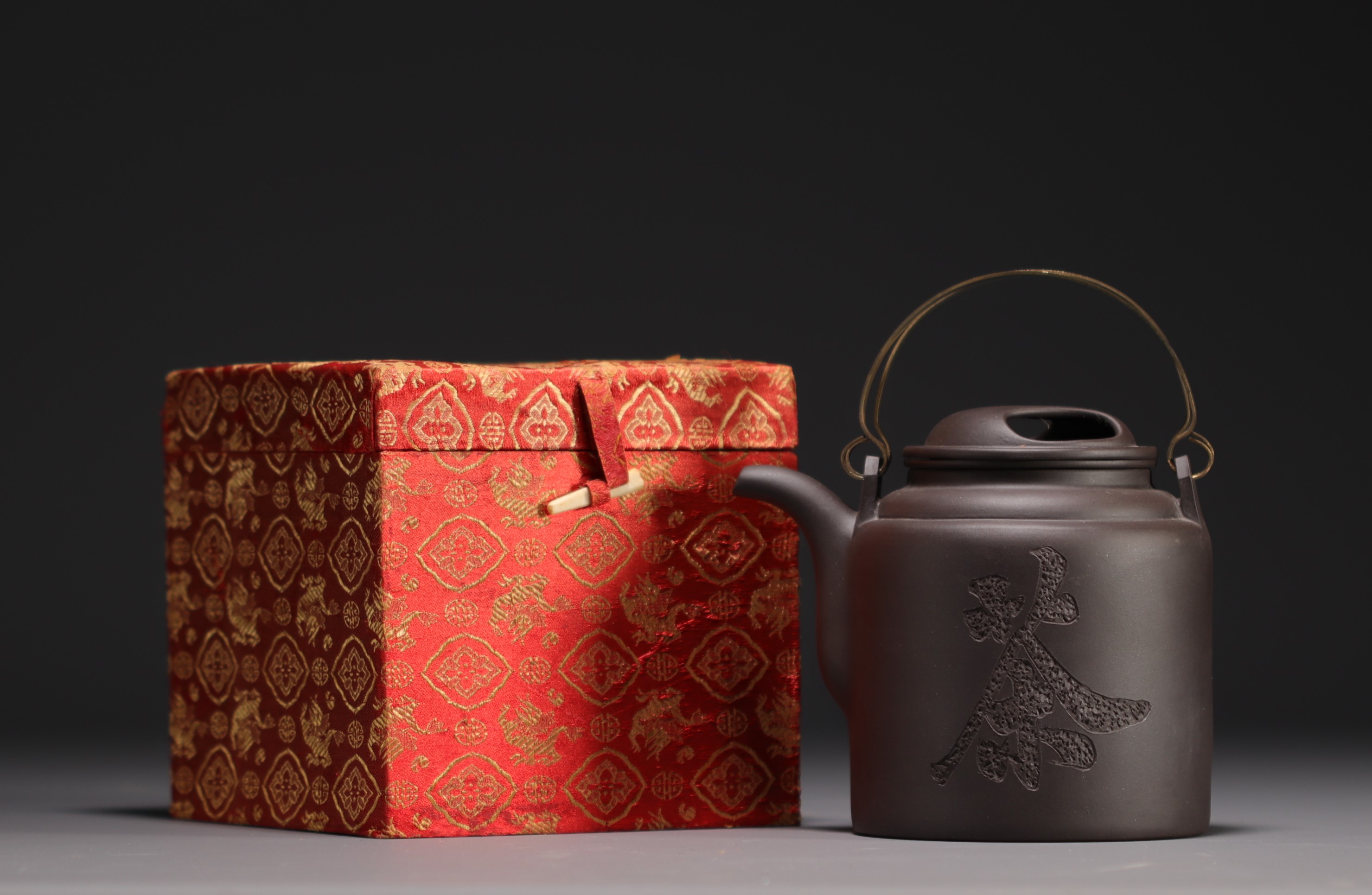 China - Yixing violet clay teapot in its box, 20th century.