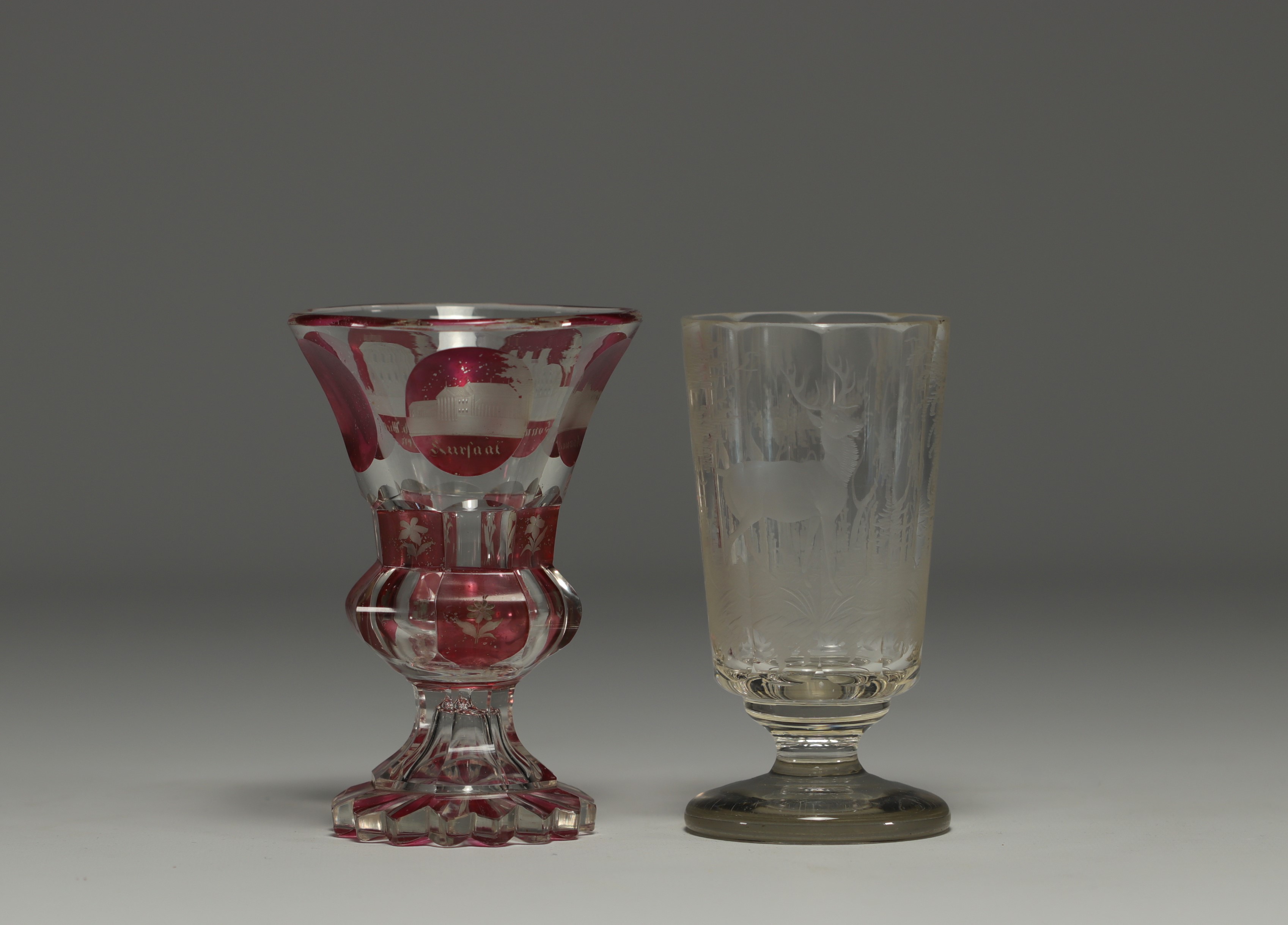 Bohemia - Pair of engraved glasses, one with a deer design and one in multi-layered glass with a cit