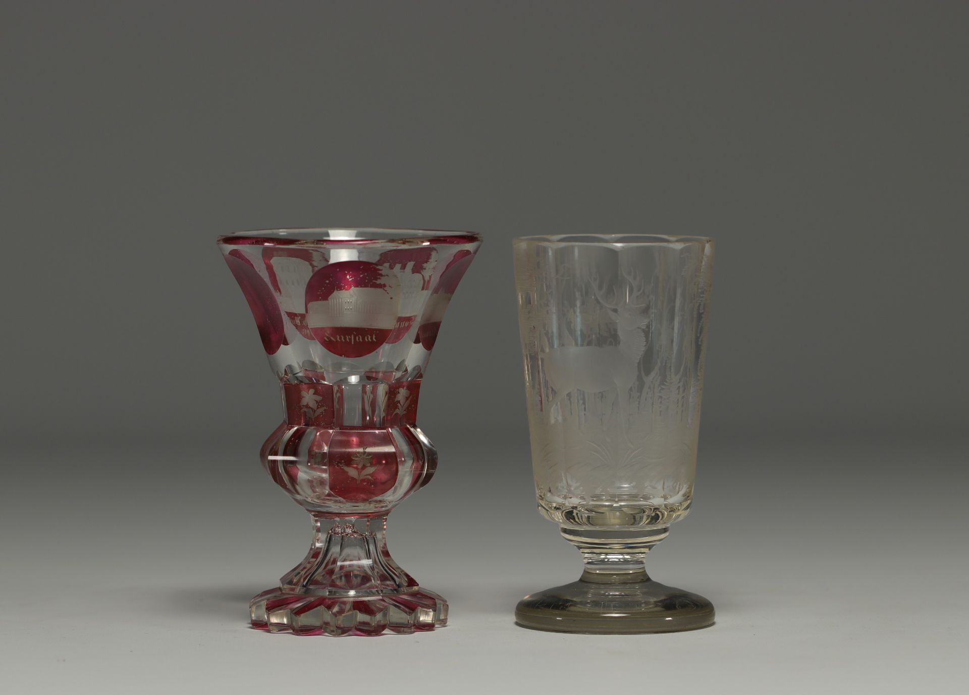 Bohemia - Pair of engraved glasses, one with a deer design and one in multi-layered glass with a cit