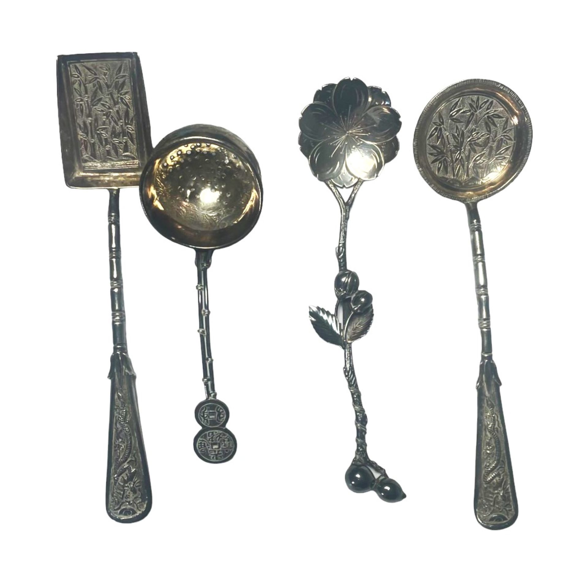 Asia - Set of four silver spoons decorated with bamboo and flowers.