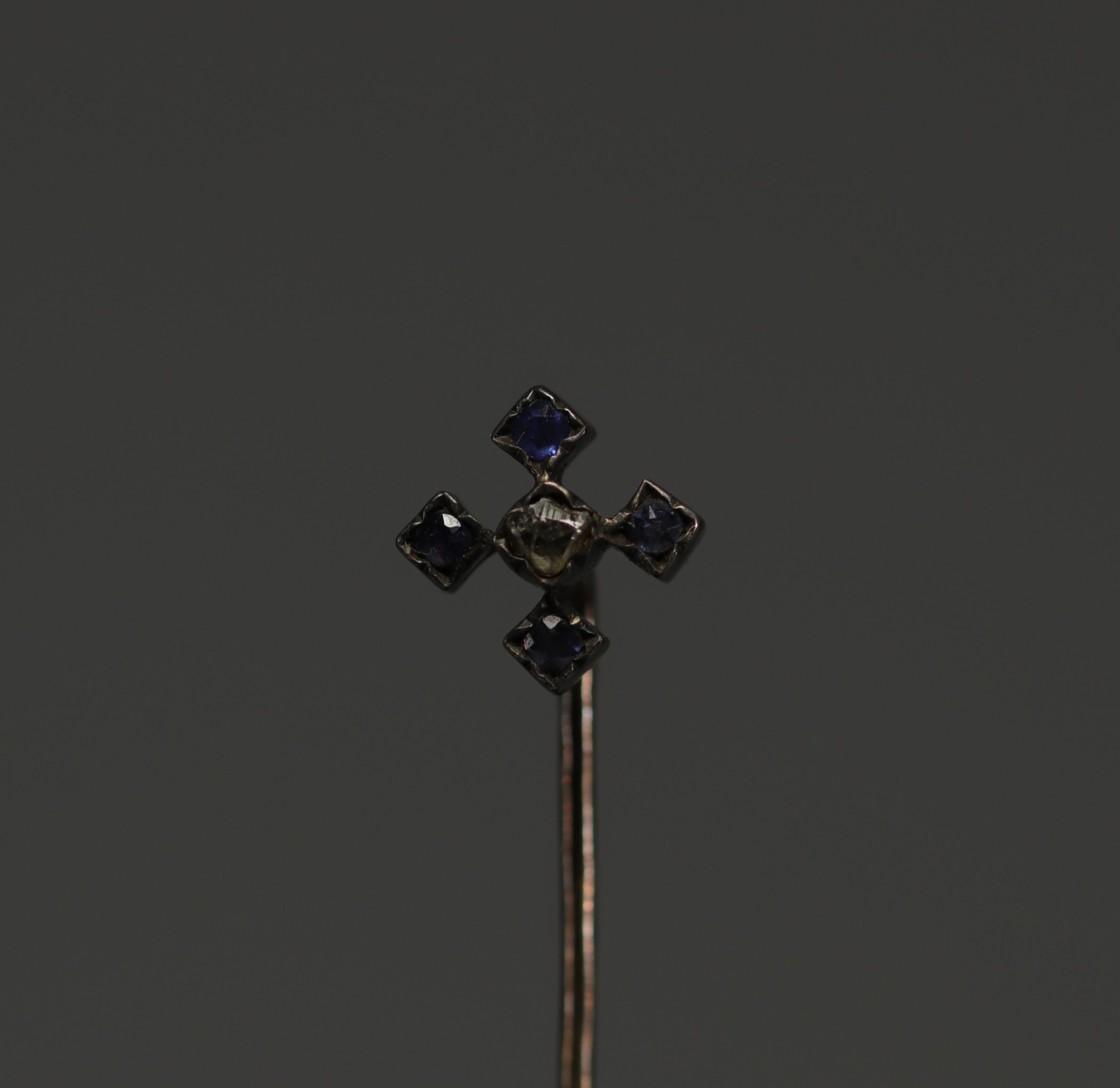 Gold tie pin, one rose-cut diamond and four sapphires.