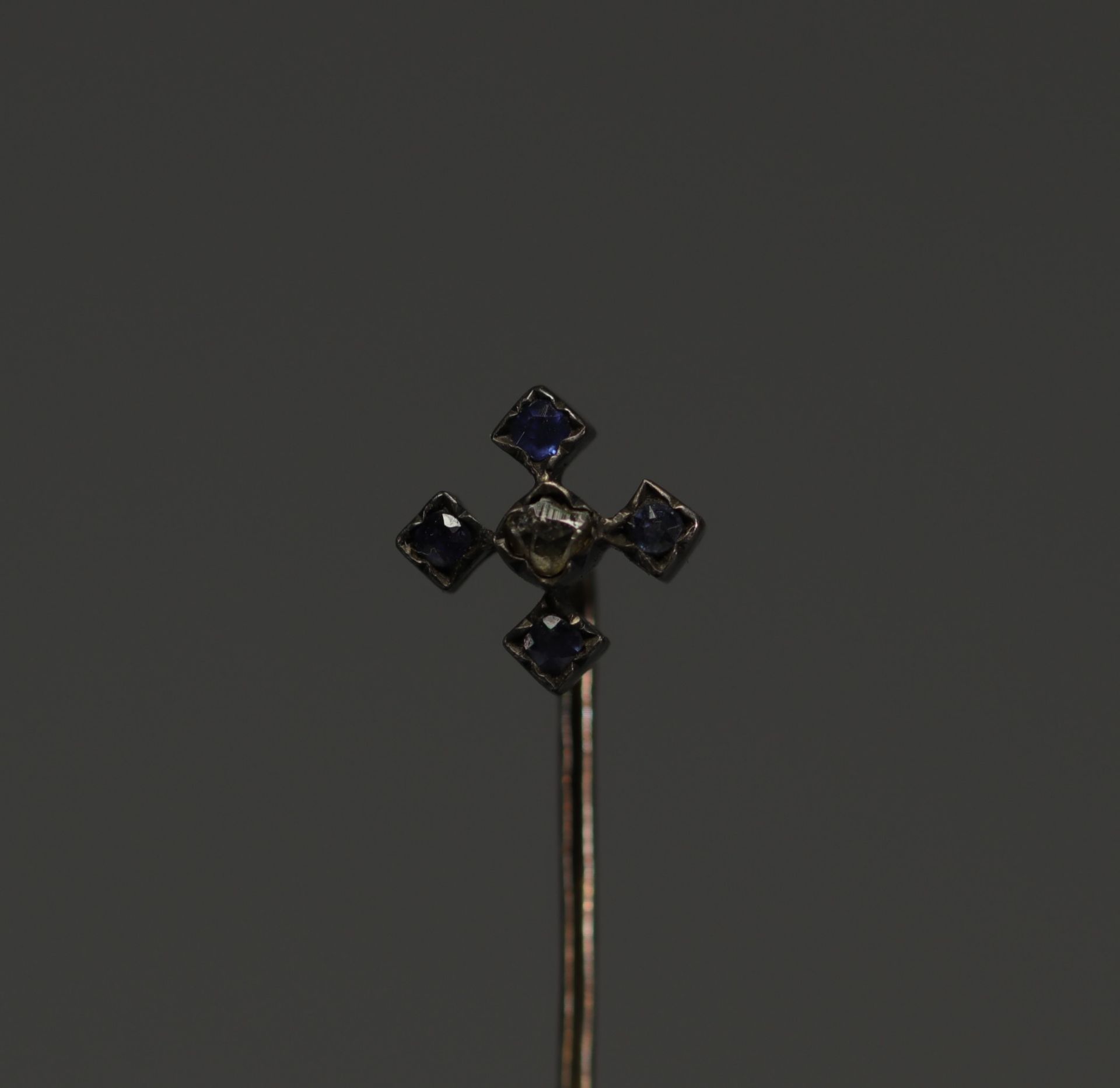 Gold tie pin, one rose-cut diamond and four sapphires.