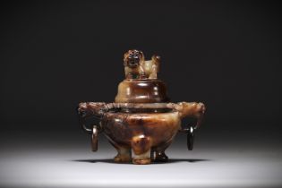 China - Tripod incense burner in brown jade, decorated with Fo dog and dragon head.