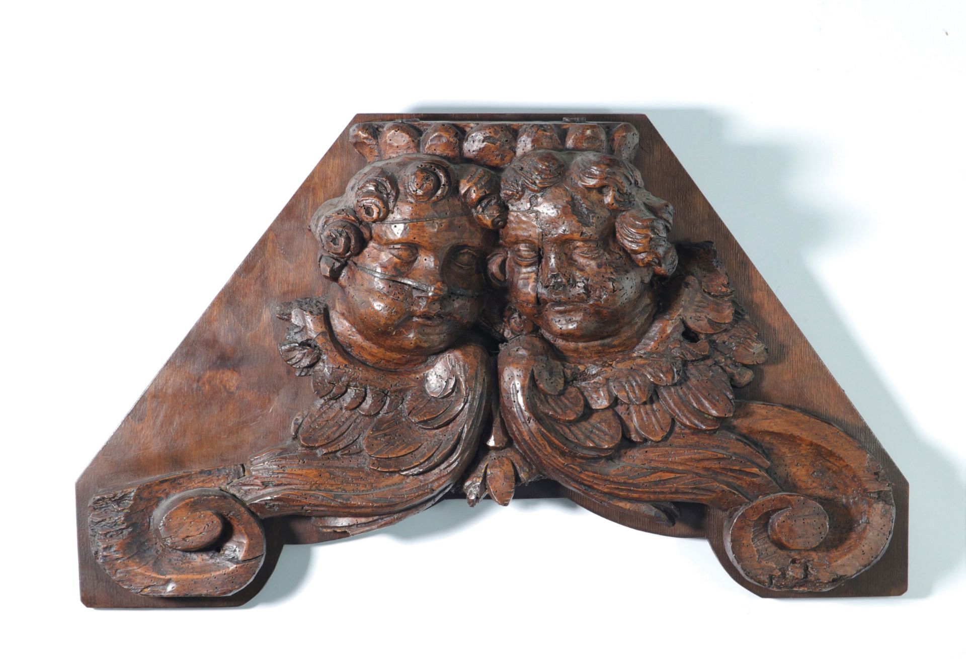 18th century wood paneling carved with angels' faces.