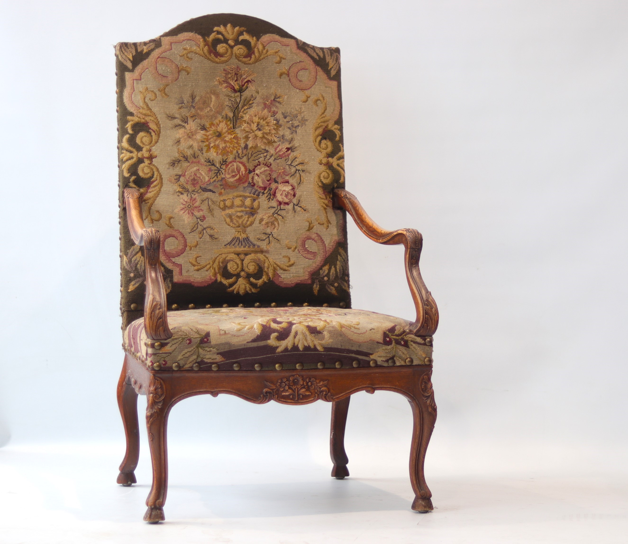 Carved wooden armchair and a seat with floral motifs from the 18th century