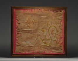 China - Embroidered silk tapestry decorated with a gold dragon on a pink background, late 19th centu