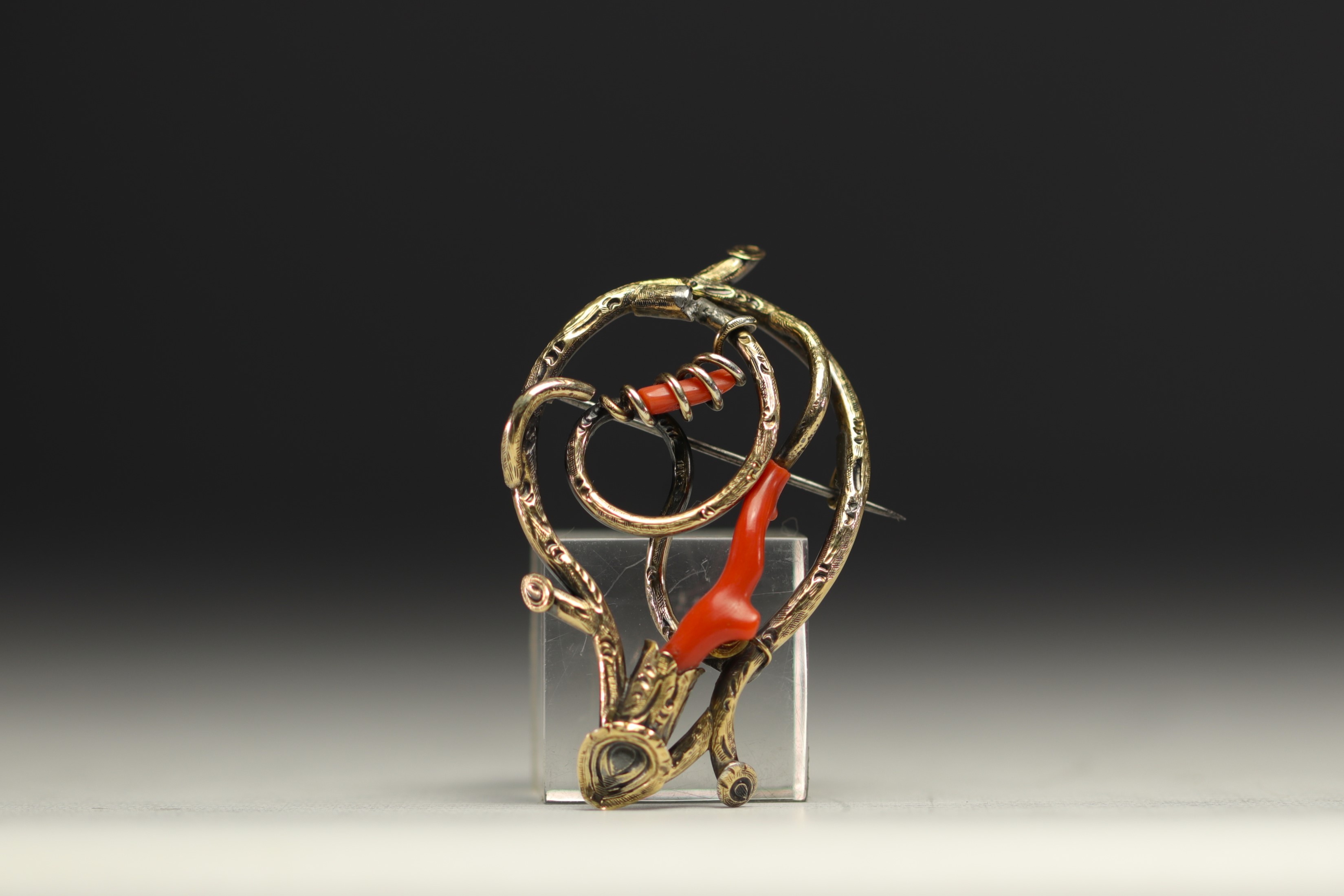 Brooch in various alloys of gold, silver and coral.
