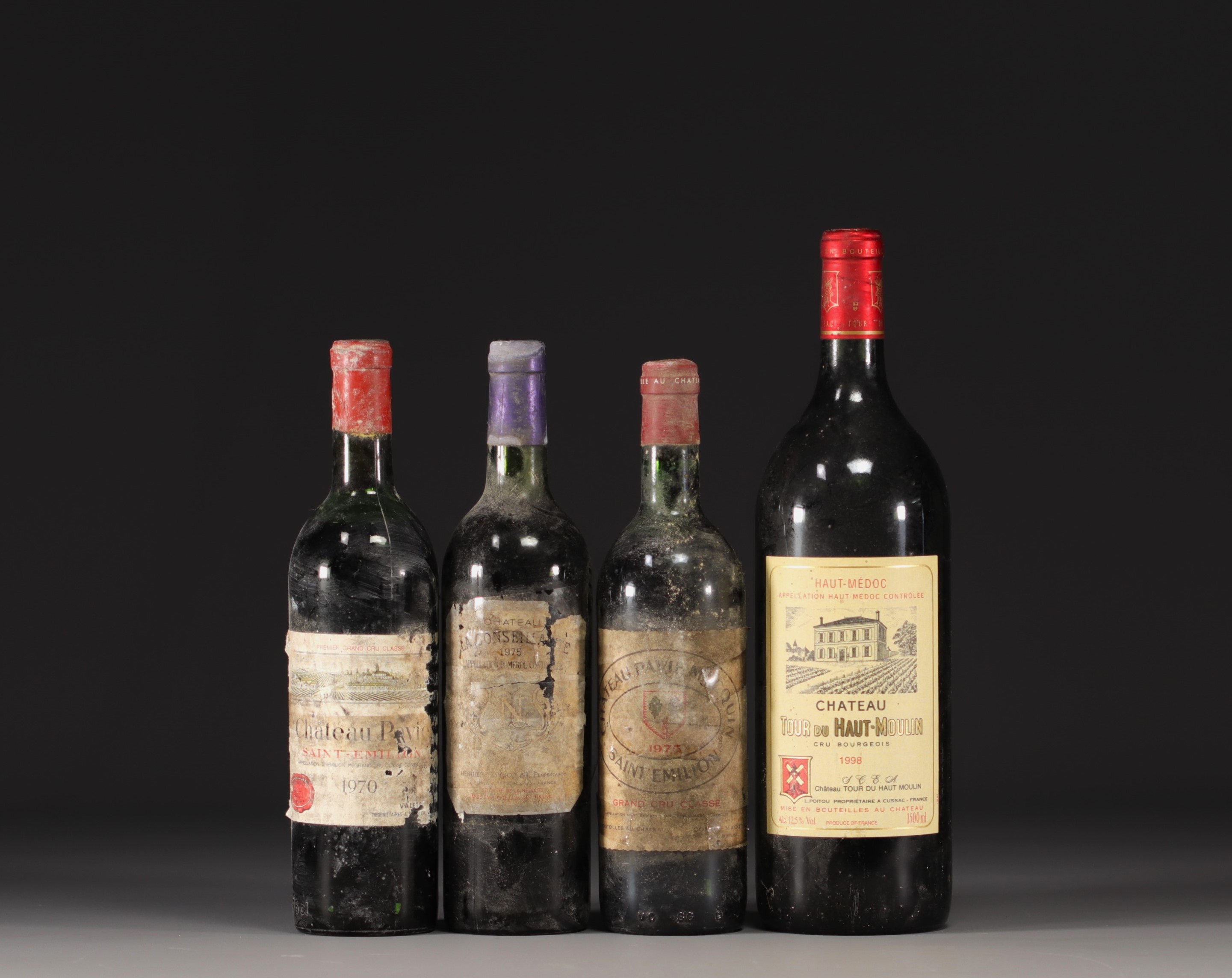 Set of 4 bottles of various Bordeaux wines.