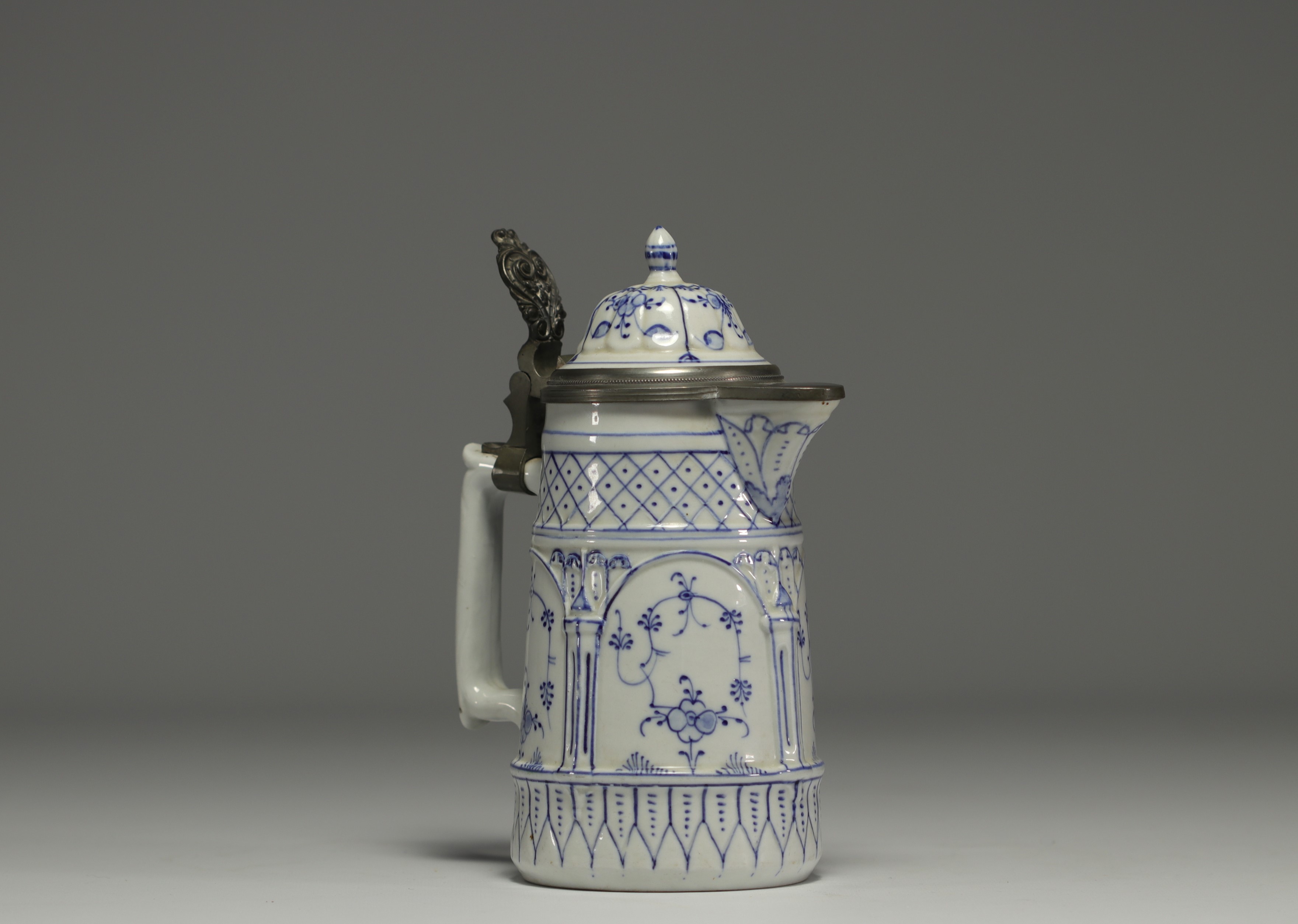 Rauenstein porcelain jug with white and blue decoration, pewter frame, 19th century.