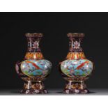 China - A pair of cloisonne enamel vases decorated with flowers and birds, 20th century.