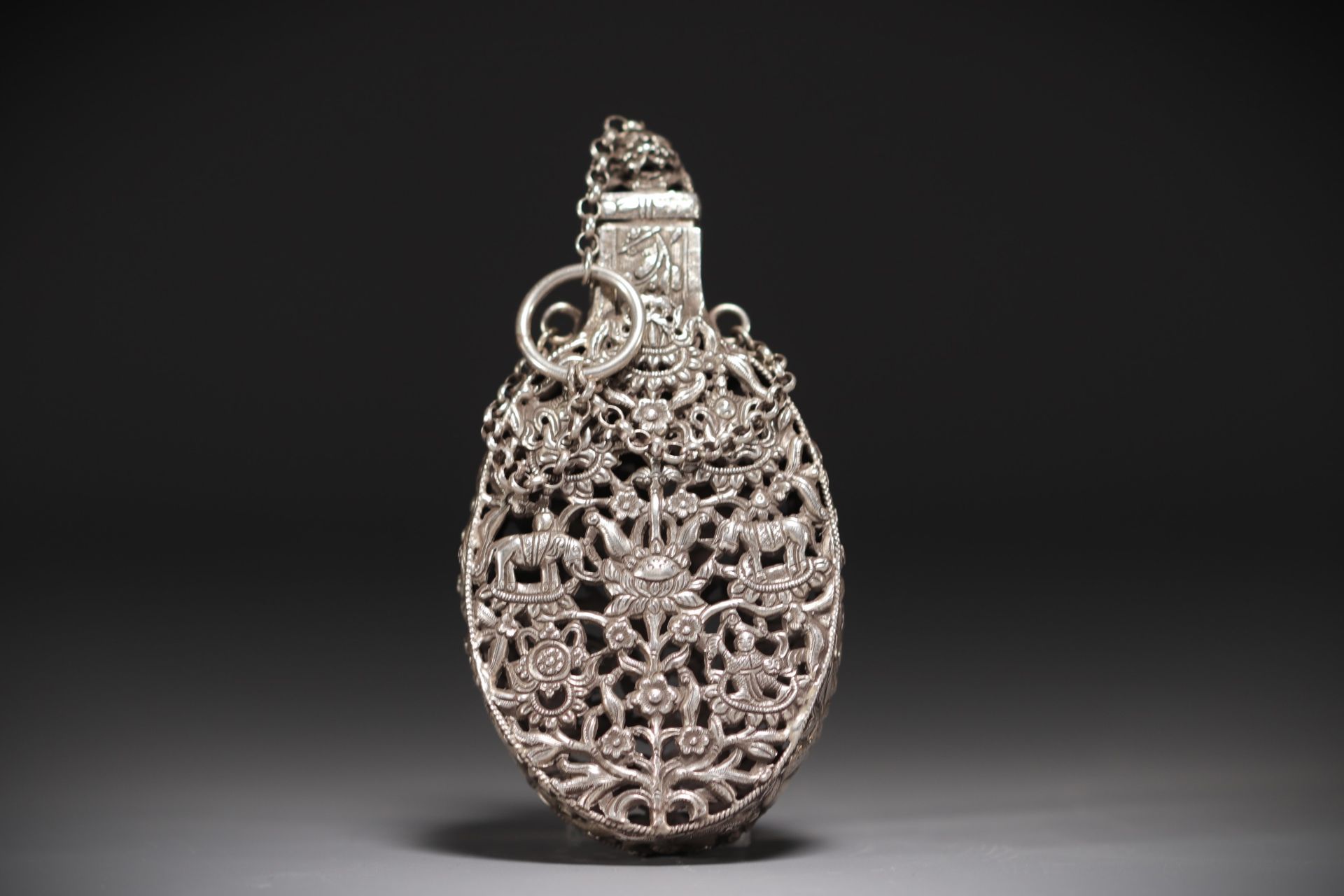 China - Carved silver incense bottle decorated with figures and elephants.