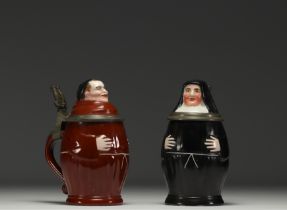 A pair of figurative porcelain mugs with lithophanied bases, by Eduard Kick in Amberg, 19th century.
