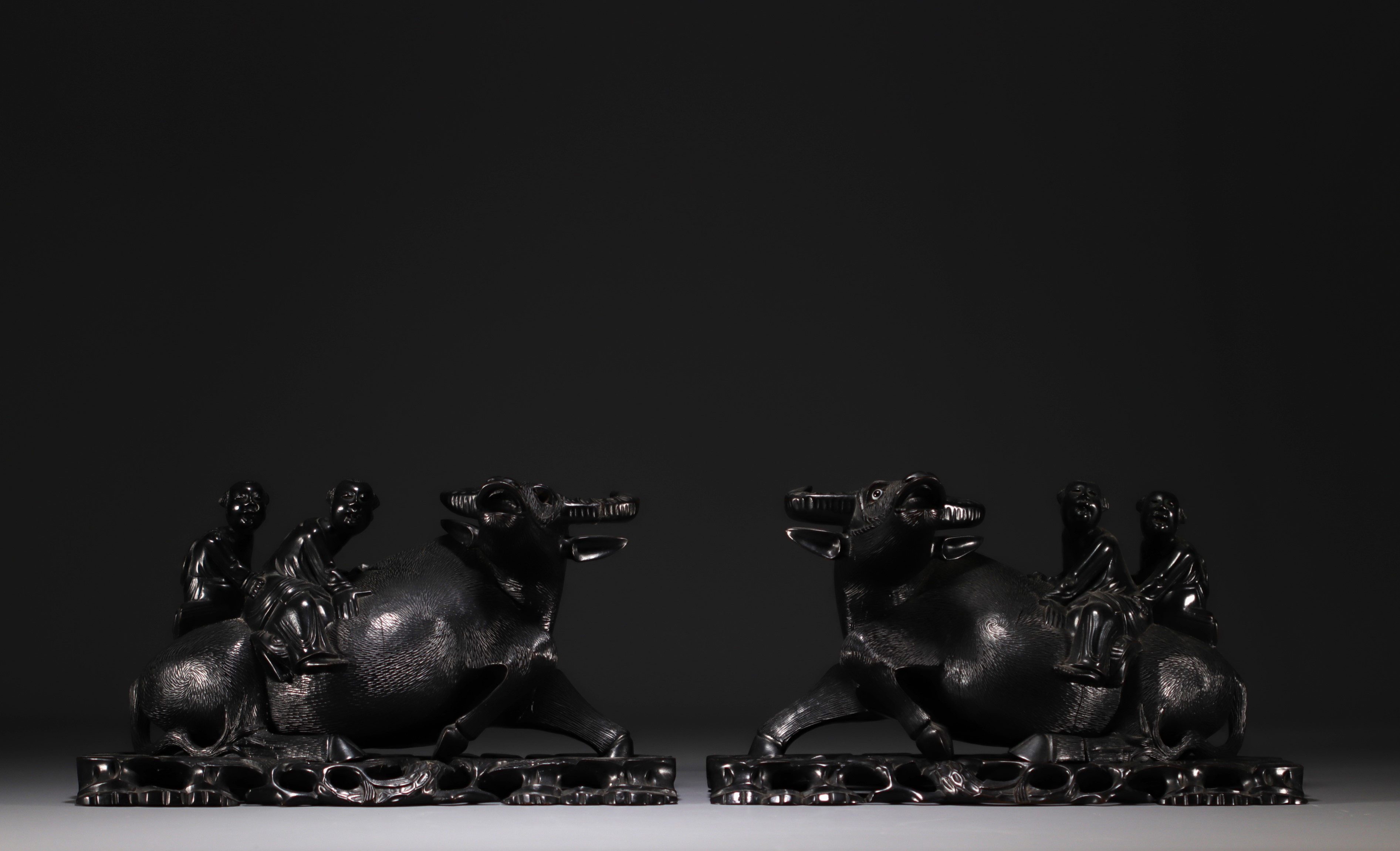 China Vietnam - Pair of wooden sculptures decorated with water buffaloes and figures.