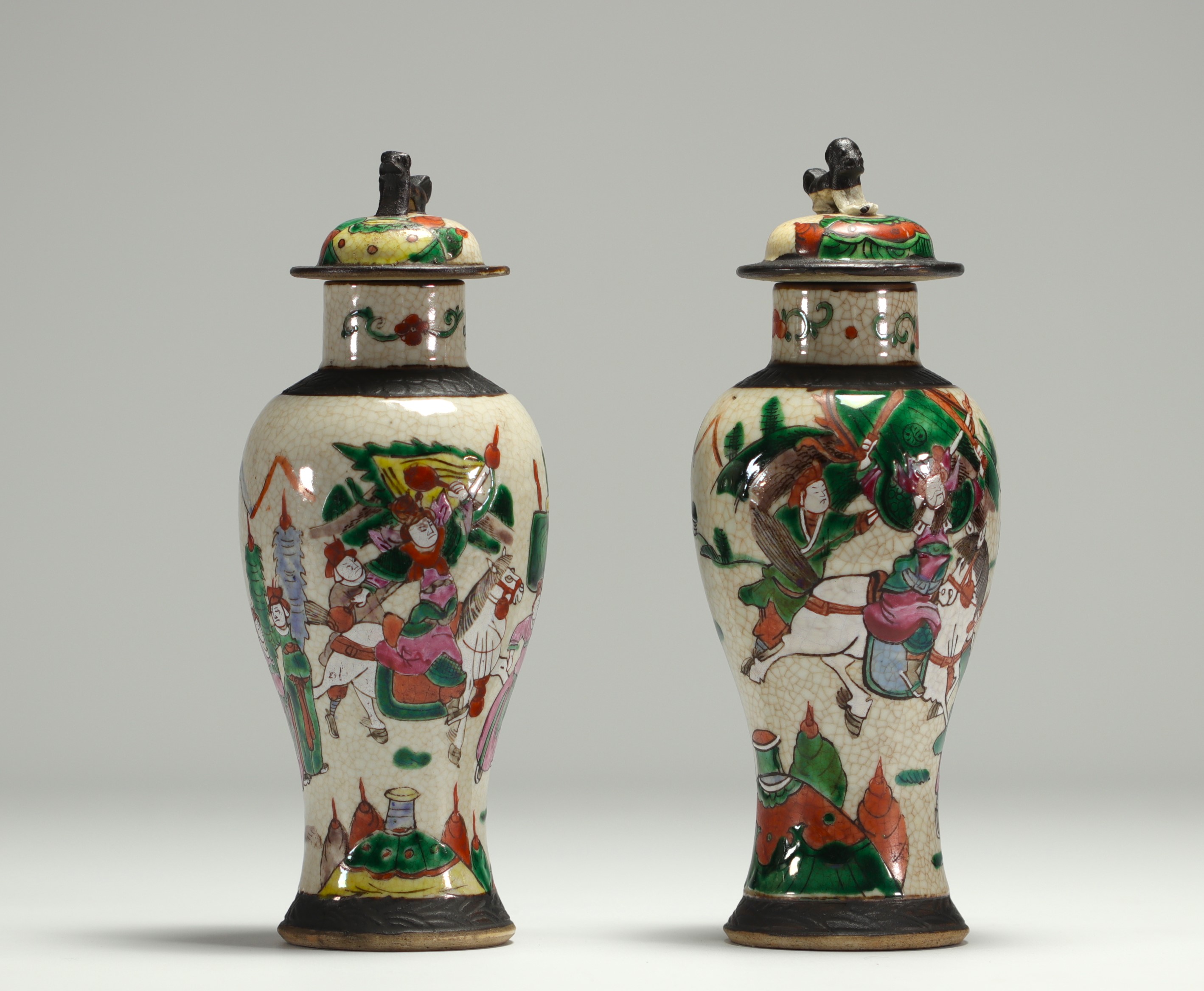 China - Pair of covered vases in Nanjing porcelain decorated with figures.