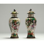 China - Pair of covered vases in Nanjing porcelain decorated with figures.