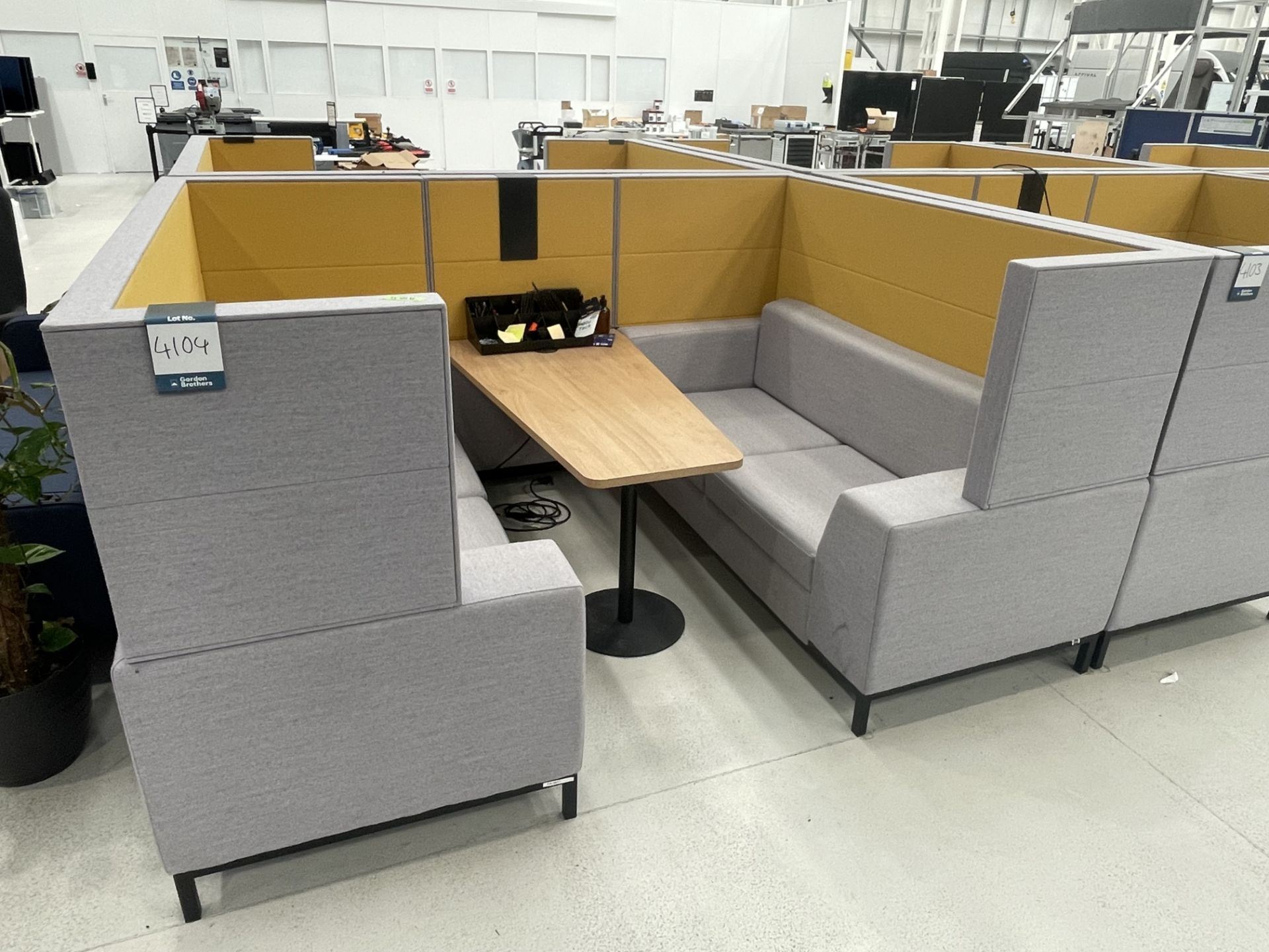 Sixteen3 Grey and yellow upholstered seating booth with wired table