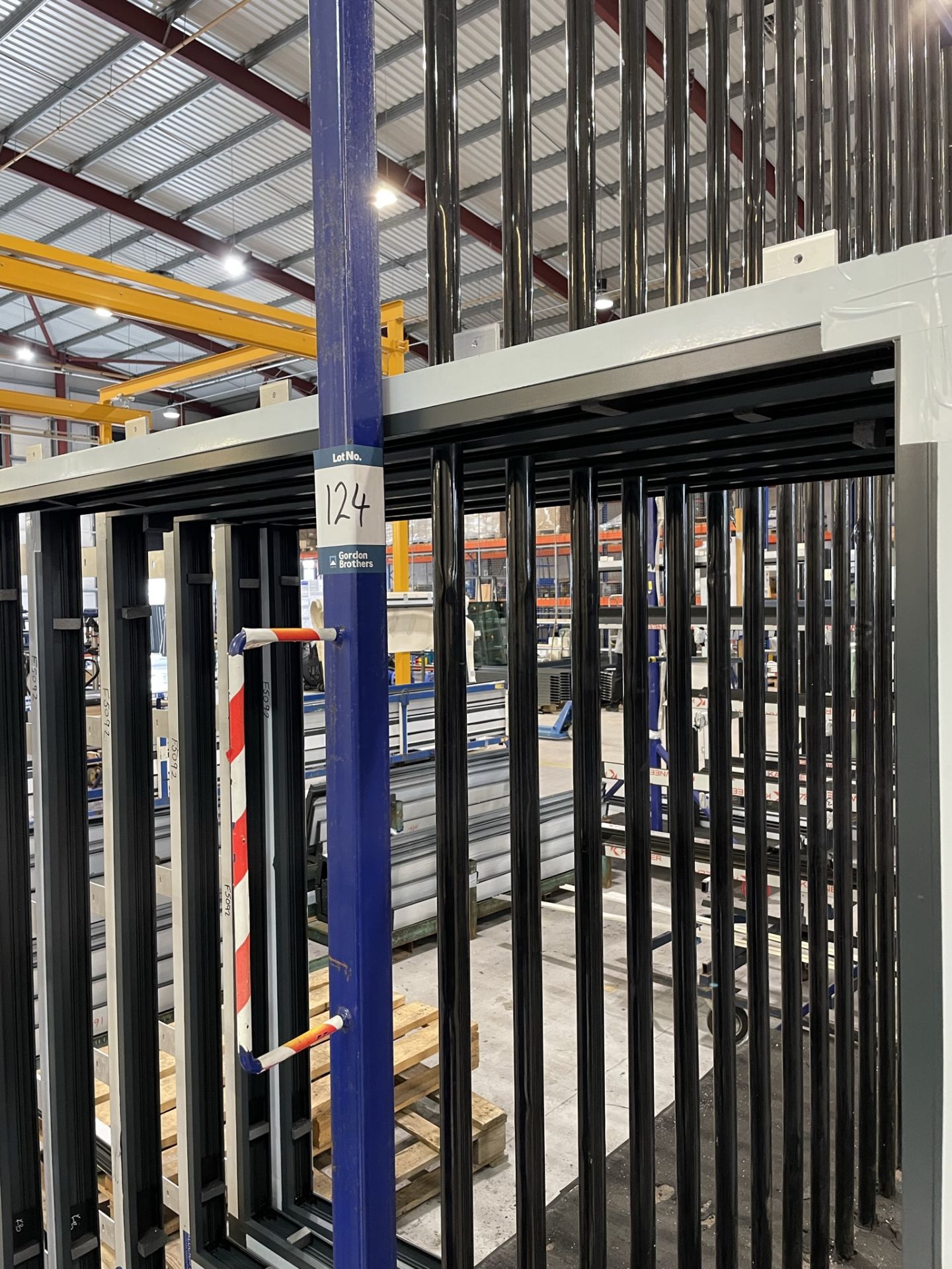 Metal framed, seventeen section vertical transporter rack, 2500 x 1200 x 3200mm approx. (contents