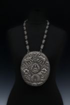 A Large Tribal Chinese Tibetan Silver Necklace Depicting a Buddha Surrounded by Elephants and