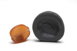 A Greek Carnelian Scarab Gem Depicting a Dolphin.