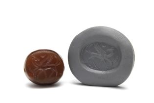 A Greco-Persian Dark Red Agate Scarab Depicting Two Goats Walking with Half Moon.