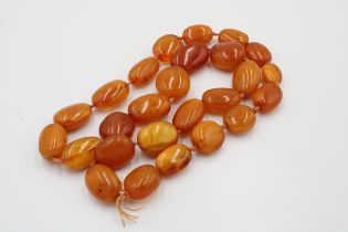 A Large Necklace of Amber Beads. L: Approximately 74cm Each Bead: L: Approximately 2cm - 3.1cm 111g