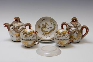 A Japanese Tea Set Decorated with Dragons.

Includes:

4 Tea Cups with Saucers
1 Tea Pot
1 Sugar Pot