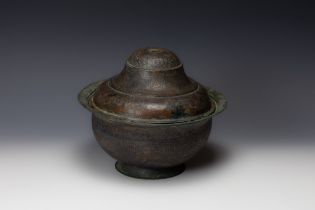 An Islamic Bronze Pot with Lid from the 12th Century with Islamic Calligraphy Engraving.

D: Approxi