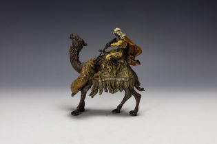 An Austrian Bergman Bronze Figure of a Hunter on the Back of a Camel Attacking a Lion, Made for the