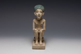 An Egyptian Style Figure of a Seated Man. H: Approximately 15.8cm