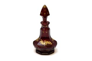 An Antique Bohemian Dark Red Glass Perfume Bottle from the 19th Century.

H: Approximately 16cm 
