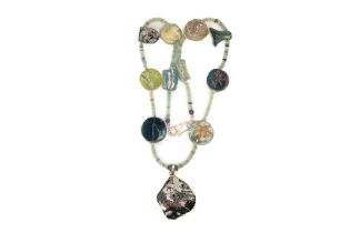 A Roman Glass Bead Necklace with a Circular Silver Pendant with Lovely Patina. L: Approximately 59