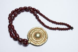 A Roman Gold Hoop Head Necklace with Red Glass Beads. 