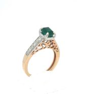 An Emerald and Diamond Ring in Rose and White Gold. Emerald Weight: Approximately 1ct Stamped 14K 5