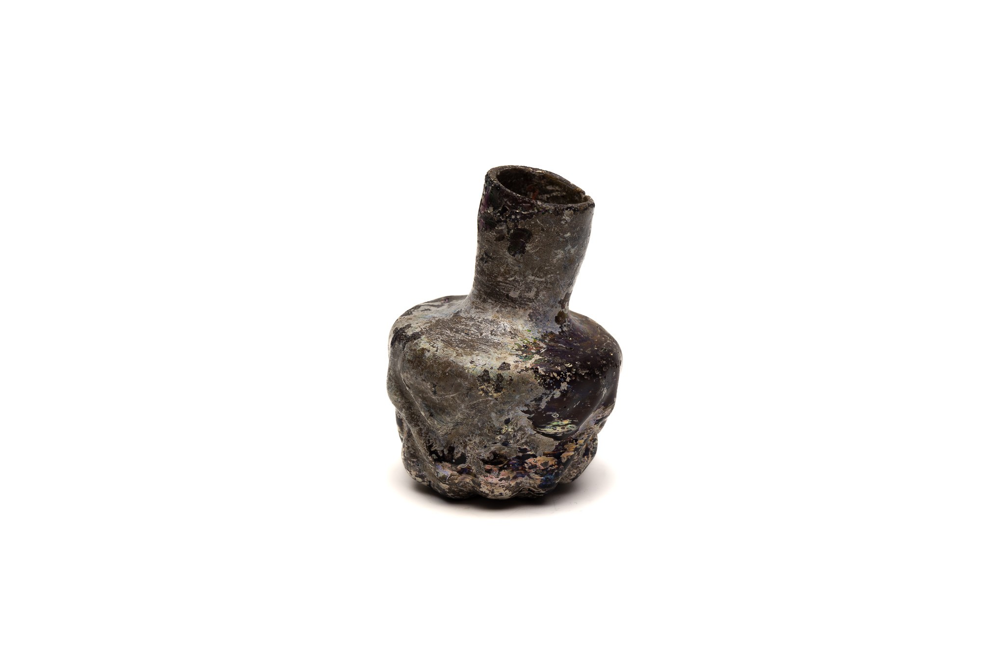 An Islamic Dark Glass Bottle with Lovely Patina and Design from the 11-12th Century.

H: Approximate