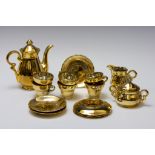 A Golden Tea Set.

Includes:

6 Teacups
5 Saucers
1 Teapot 
1 Milk Pot
1 Sugar Bowl 