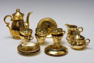 A Golden Tea Set.

Includes:

6 Teacups
5 Saucers
1 Teapot 
1 Milk Pot
1 Sugar Bowl 
